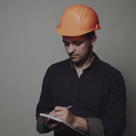 young man architect in building helmet