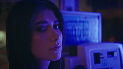 depressed model posing neon light call box closeup. unhappy woman looking camera