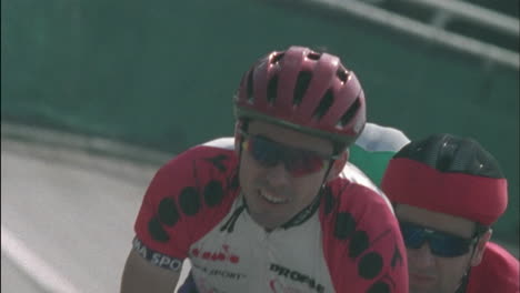 several cyclists ride around a circular track