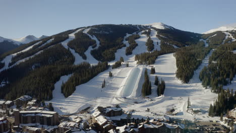 aerial drone copper mountain colorado ikon epic pass winter spring sunny first light sunrise morning sunset half pipe chairlift ski runs center village cinematic slowly down jib motion