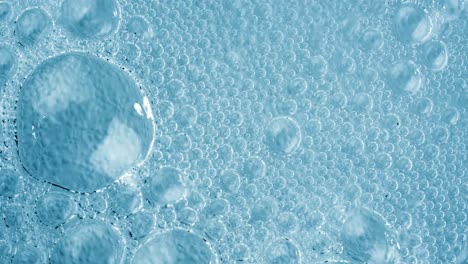 Oxygen-bubbles-in-water-on-a-blue-abstract-background-on-super-slow-motion.