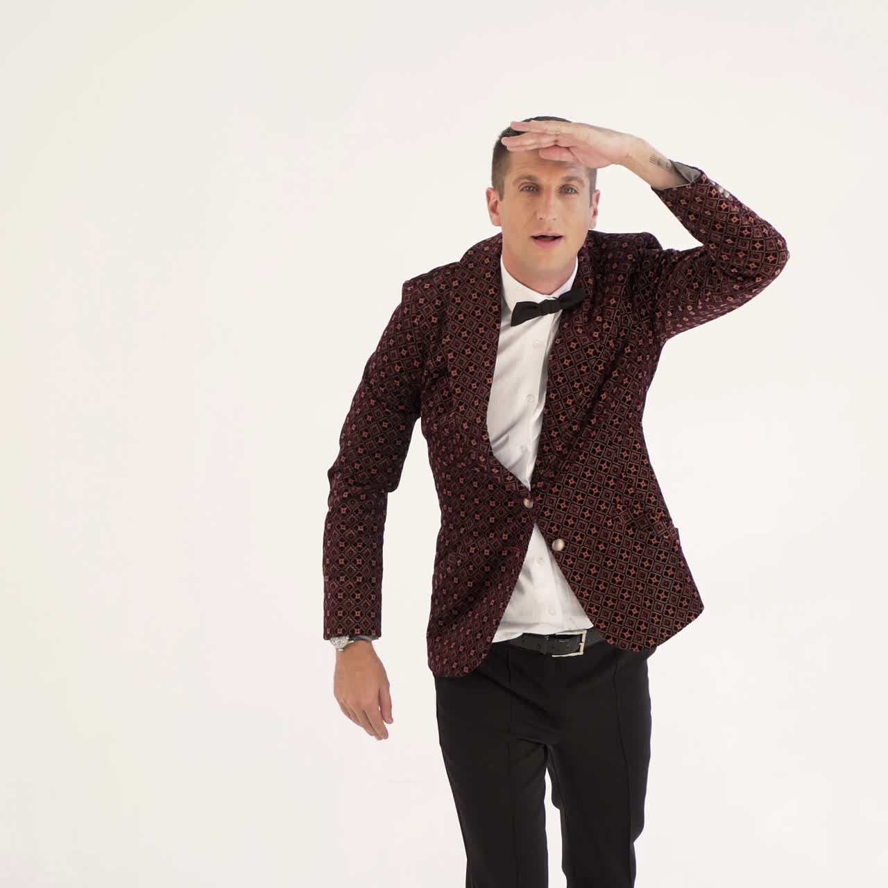 charismatic man in a brown suit is showing a typical golf player on the field. Parody in the studio