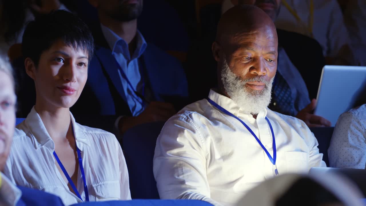 Business people attending business seminar in auditorium 4k