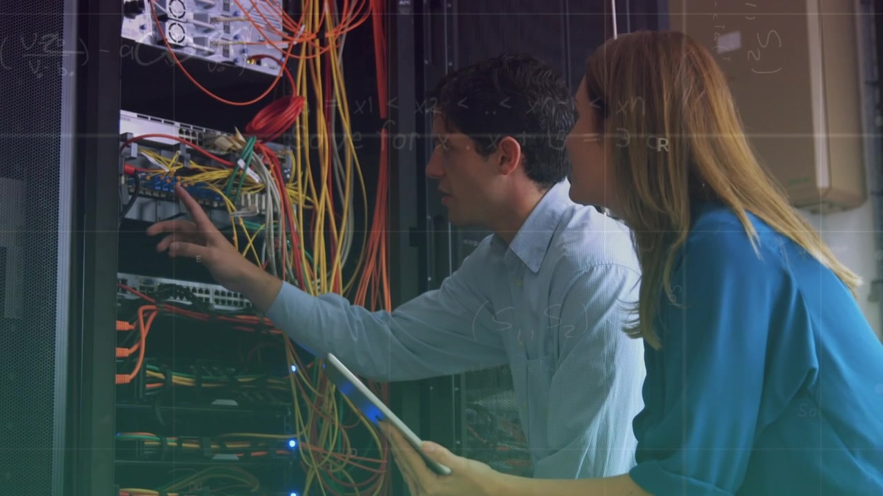 Animation of data processing over caucasian male and female it technicians and computer servers