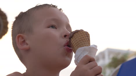 child eating chocolate ice cream outdoor