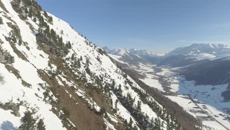 Aerial-landscape-of-a-village-of-Livigno-in-Italy,-placed-in-alpine-valley-between-high-and-steep-mountains