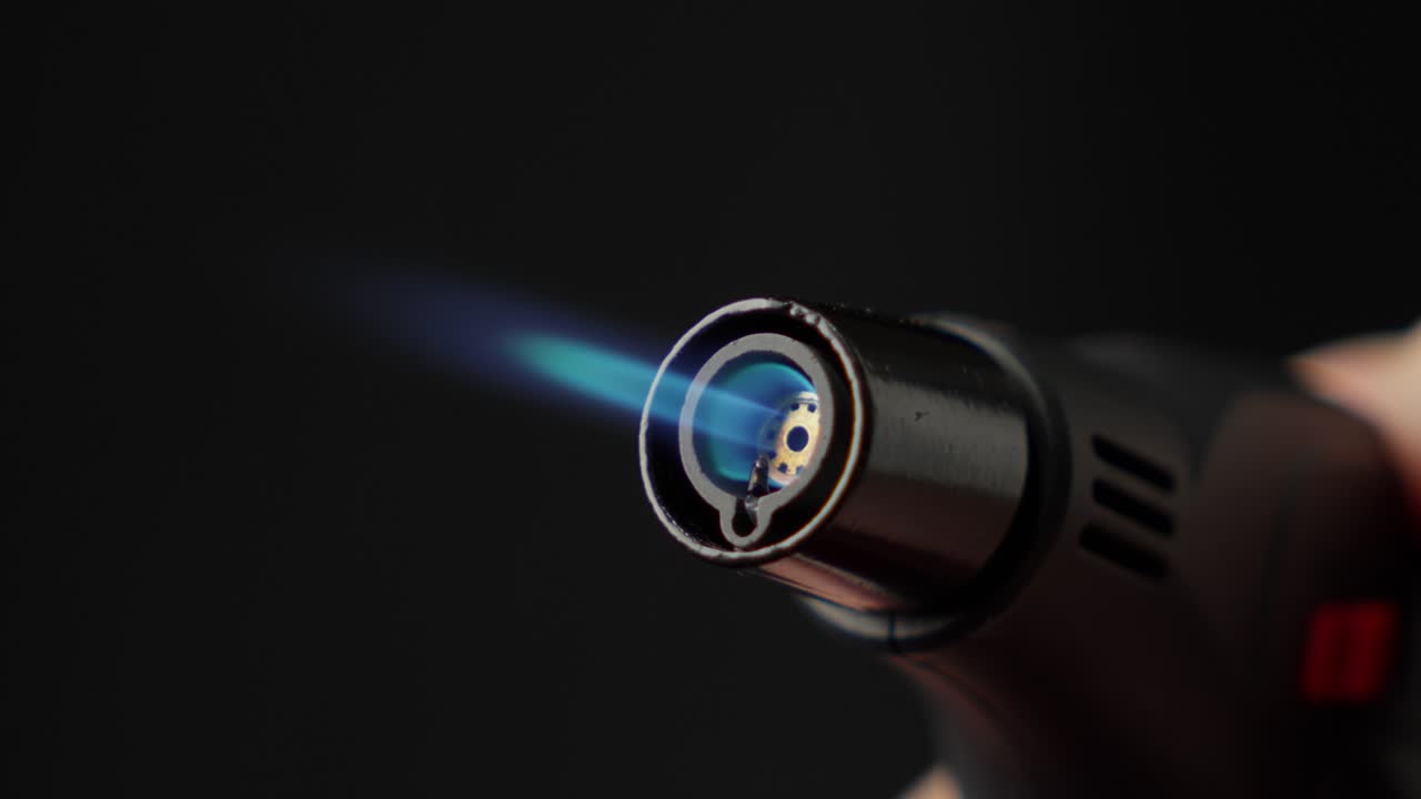 Butane Torch Lighter With Blue Flame and Black Background, Close Up Shot
