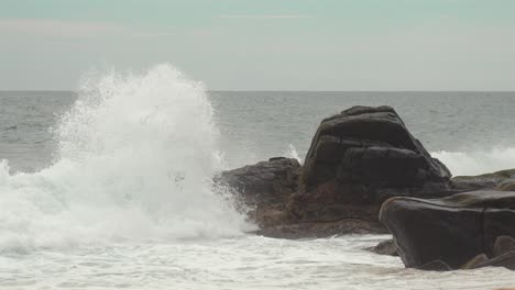 rocky shore waves crash on mirissa coast, evoking calm and natural strength