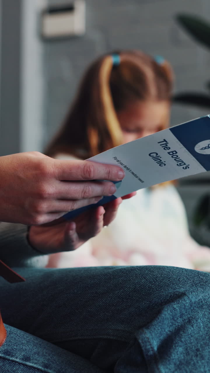 Paziente che tiene in mano una brochure di una clinica medica nella sala d'attesa