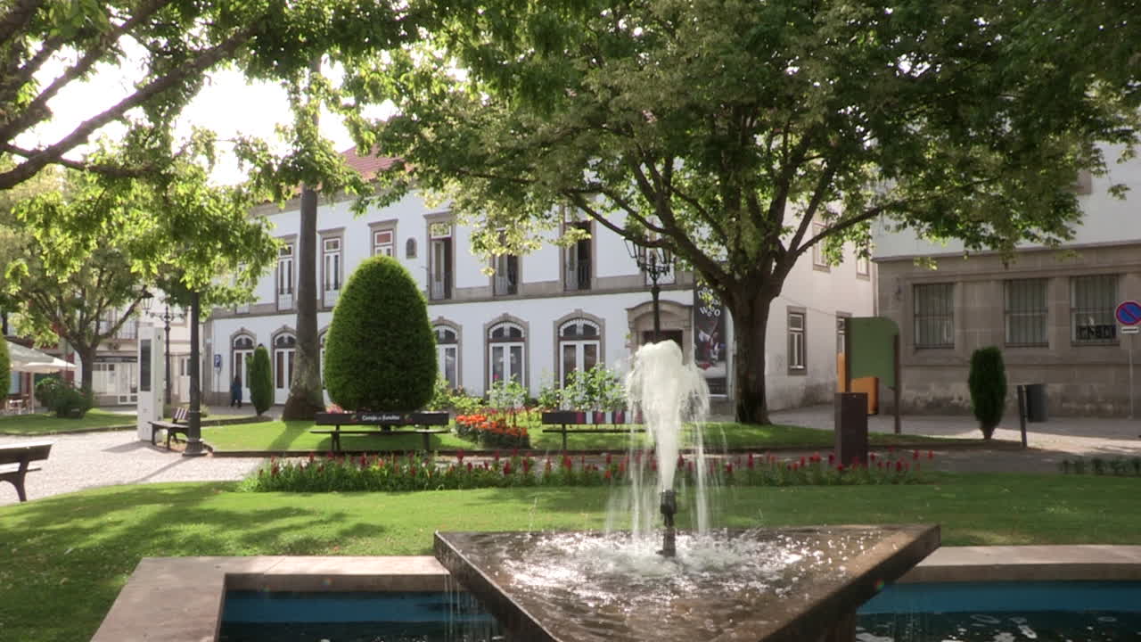 Pequeño jardín con una fuente de agua en la ciudad.
