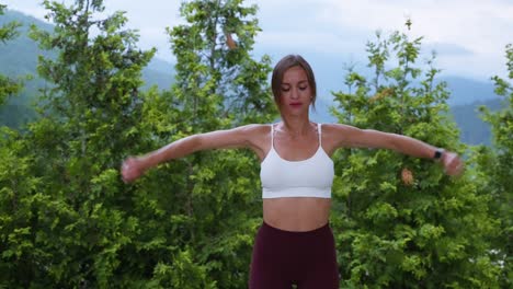 sportswoman warming up arms and shoulders before training