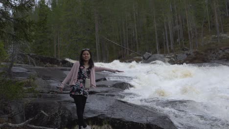 Girl-reaching-out-to-waterfall.-Slowmotion