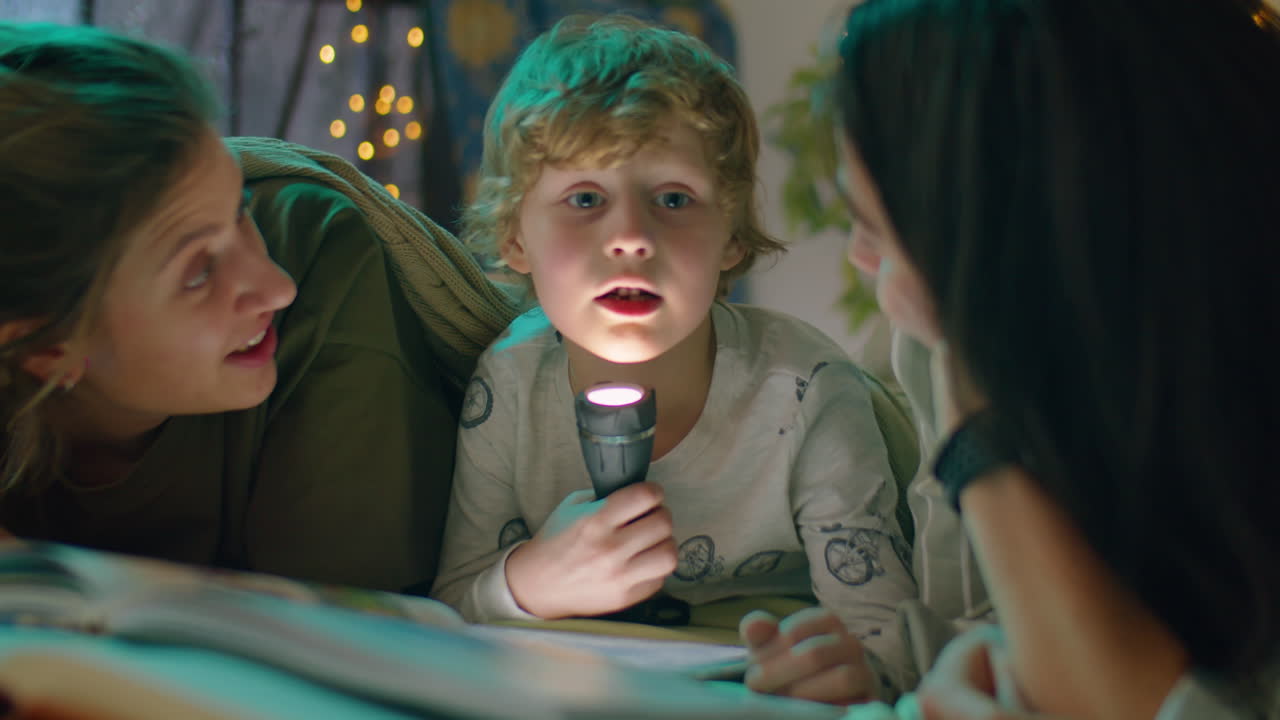 Happy Lesbian Couple and Little Son Laughing in Bed