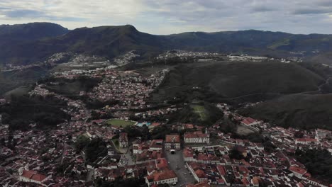 painterly panorama landscape with historic colonial city of ouro preto in minas gerais, brazil, on a hill with the central tiradentes square in the foreground and wider mountainous landscape behind