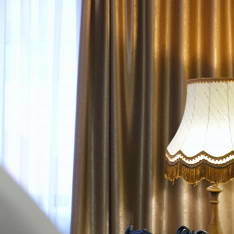 successful businessman near the window. handsome man in white shirt at modern room in a hotel. bearded young man on the background of luxury curtains