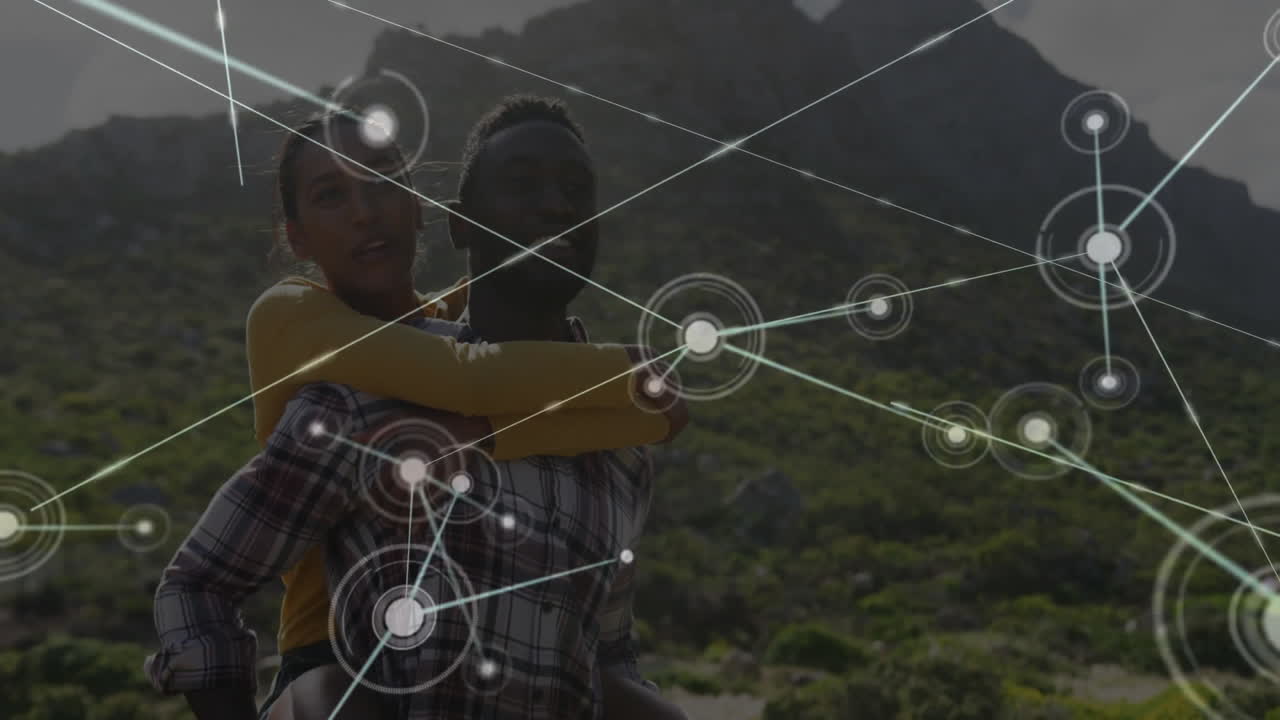 Romantic couple riding piggyback on hillside, showing technology network nodes and connecting lines