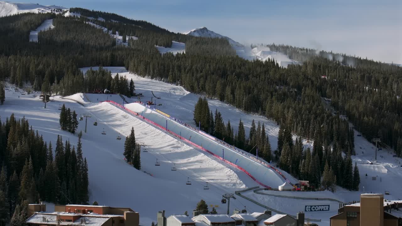 Copper Mountain Resort center village aerial drone chairlifts gondola Ikon Pass Alterra snowboarding snow ski riding trails morning winter solstice December halfpipe snow guns trees forward motion