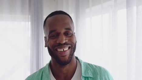 Portrait-of-smiling-young-man-at-home