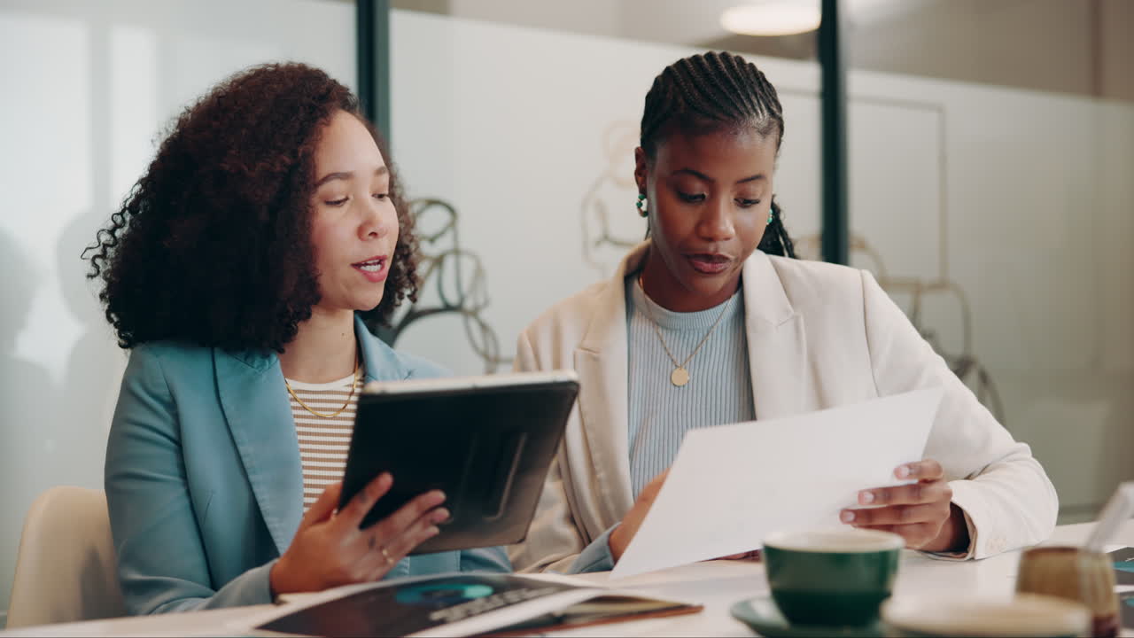 Two Businesswomen in a Meeting Discussing a Project