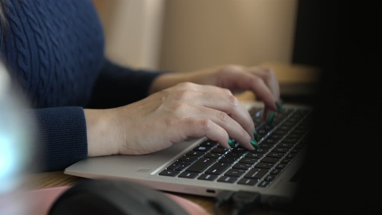 Women typing on laptop keyboards, office work, close up view