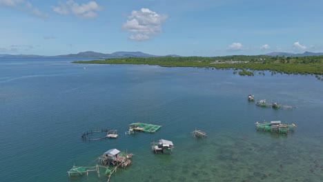 Aerial-panning-up-footage-of-fishermans-floating-village-and-fish-farms-in-the-Philippine-ocean