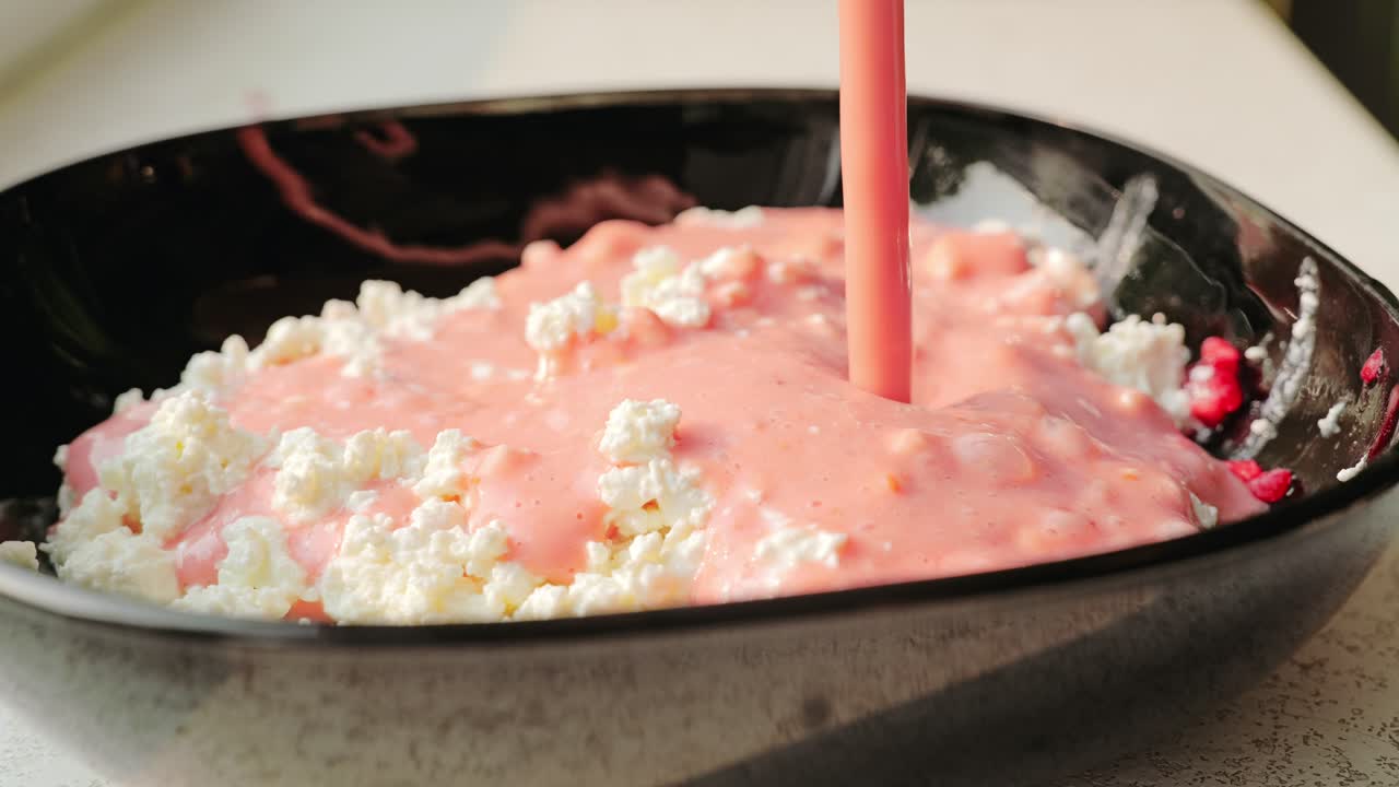 Fruit smoothie made of banana, mango, raspberries poured over cottage cheese