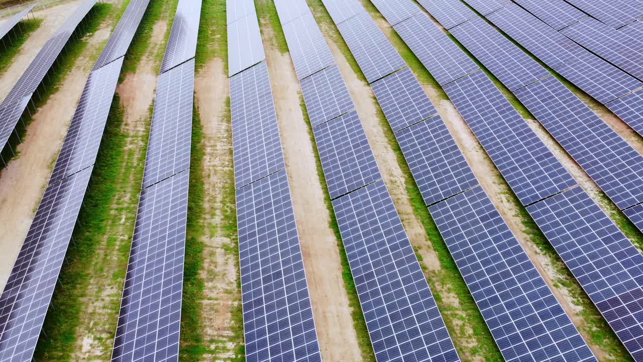 Endless lines of solar panels, aerial drone side fly view