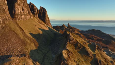 Crumbling-rocky-spires-and-cliffs-in-early-morning-winter-light-with-sea-visible-on-horizon