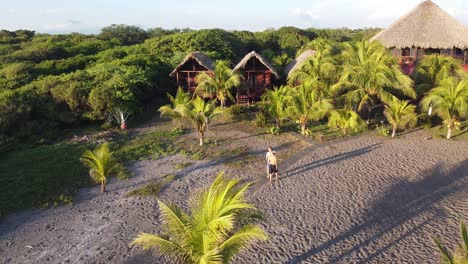 Chicos-Relajándose-En-La-Playa-Frente-A-Su-Albergue