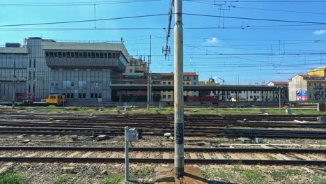 train travels through urban milan railway station