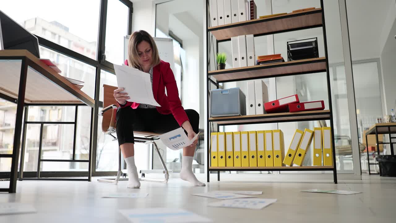 Woman working with documents in office