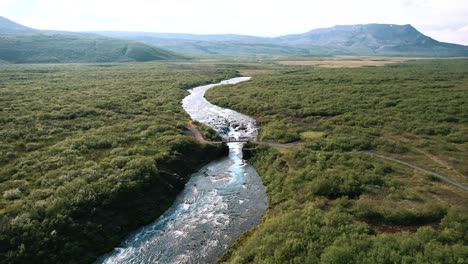 stunning panoramic view of hraunfossar and barnafoss waterfalls emerging from lava, iceland, drone shot