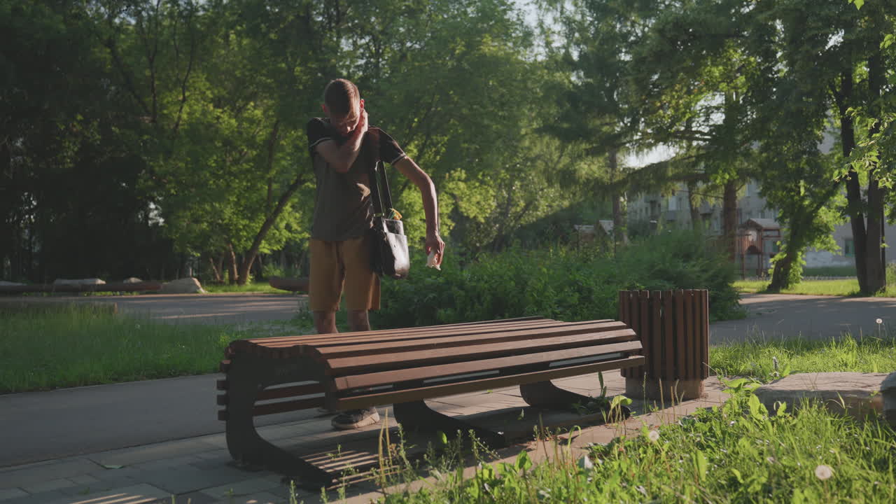 Silent Search Activity, Man Inspecting Belongings Quietly Outside, Quiet Man Carefully Searches Pockets And Bag, Serene Suburban Setting As Man Methodically Checks Pockets And Bag For Items