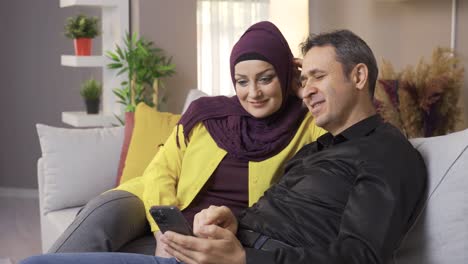 happy muslim husband and wife spending time at home.