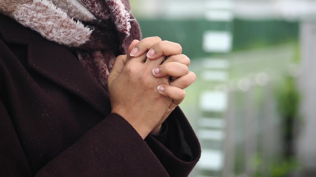 Close-up of a Person Clasping Hands Together in Prayer
