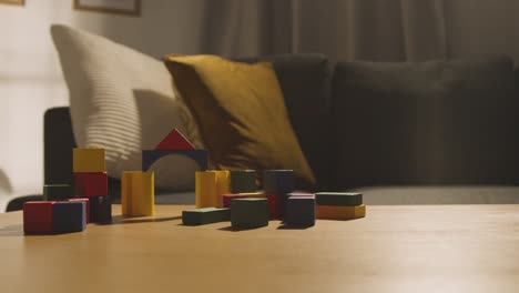 colourful wooden building blocks on table at home for learning and child diagnosed with asd 3