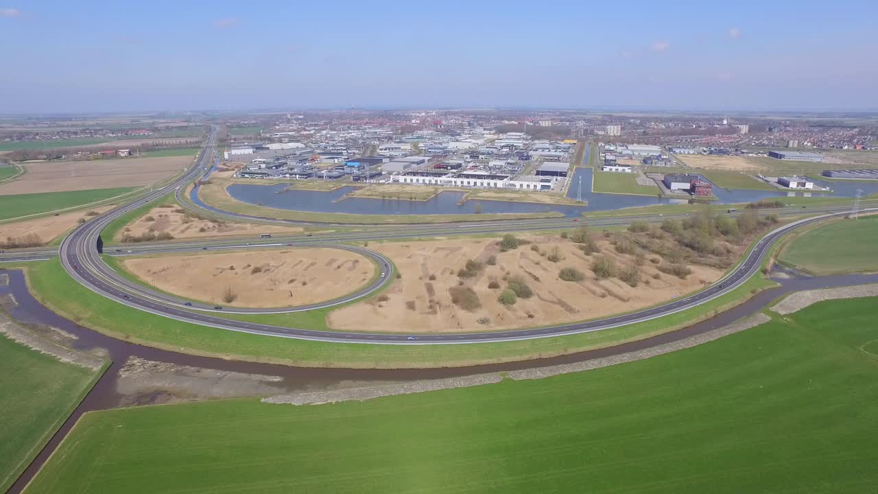 Aerial view of a city with highway interchange and landscape