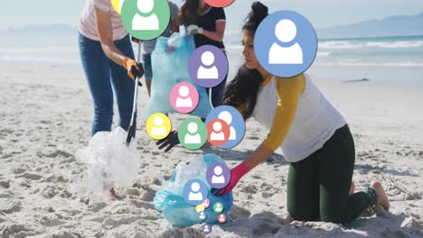 Animation-of-falling-people-icons-over-diverse-female-group-picking-up-rubbish-from-beach