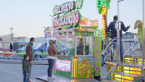 family at a fun fair with dinosaur food stall