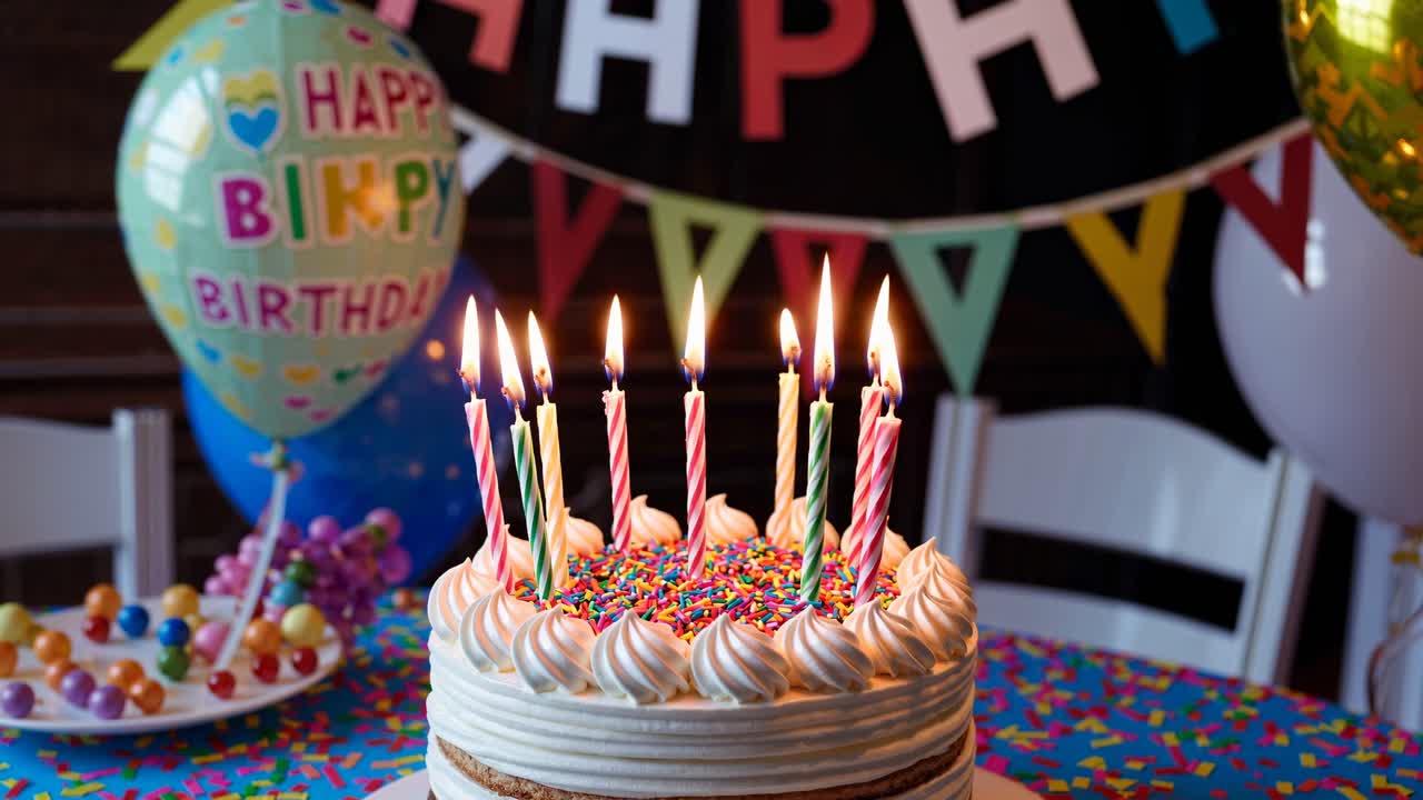 Colorful birthday scene with a cake and lit candles, captured at eye level
