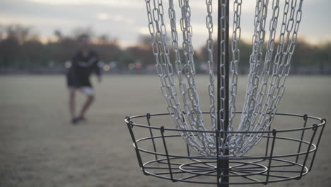 Disc-Golf-Putt-into-Disc-Golf-Basket-in-Slow-Motion