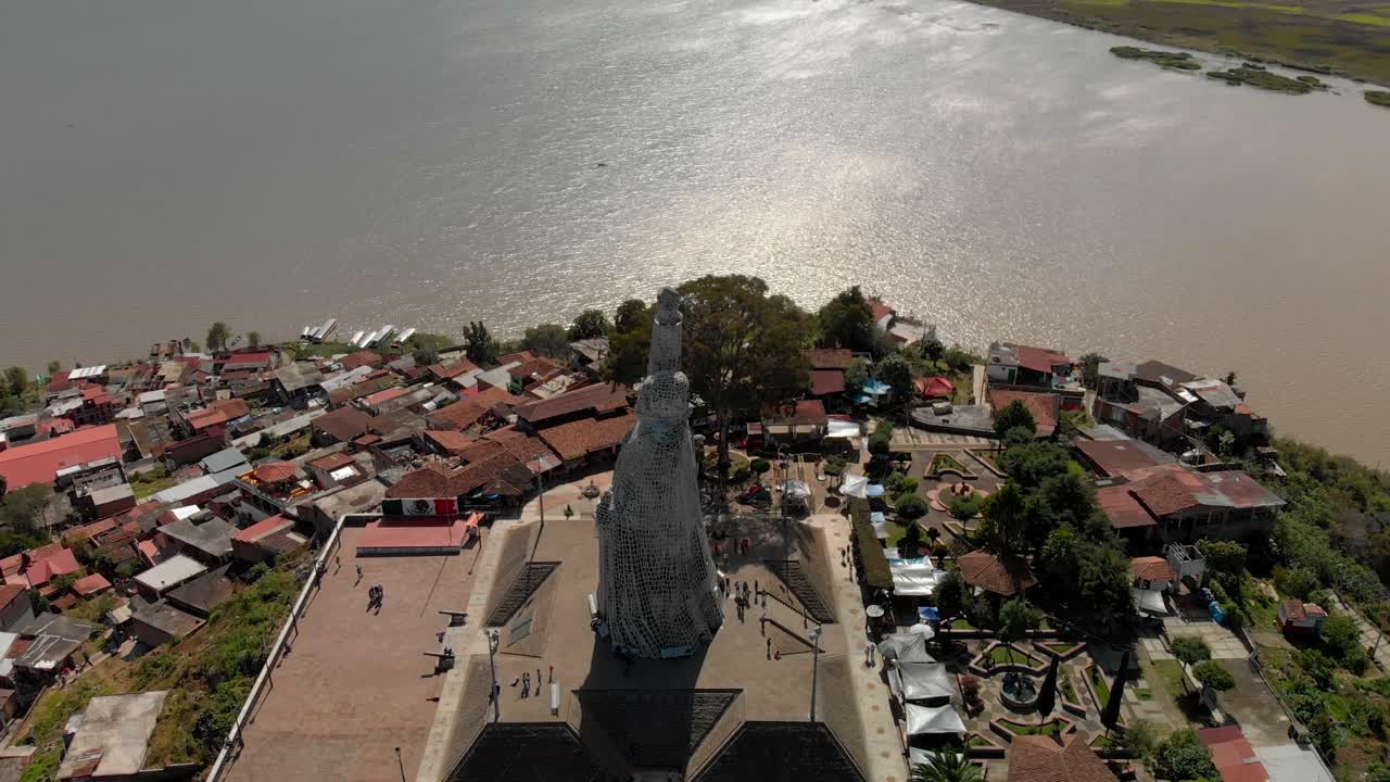 LONG DRONE ORBIT OF MORELOS STATUE IN JANITZIO ISLAND IN MEXICO