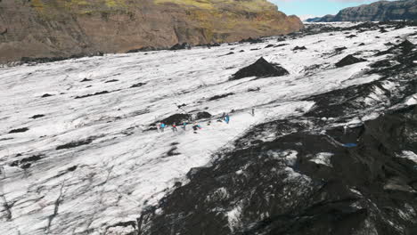 aerial parallax around photographers shooting on surface of icelandic glacier