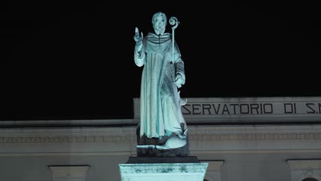 saint antonino statue in sorrento's piazza at night, italy