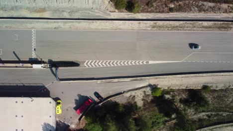 Cars-on-the-castelloli-speed-circuit-in-barcelona-during-a-sunny-day,-aerial-view