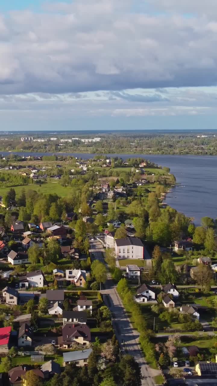 Aerial view of Katlakalns residential area and lake, calm spring scene. Vertical orientation
