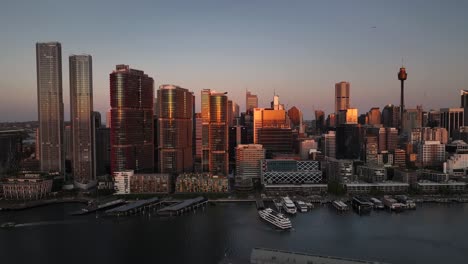 cityscape of darling harbour at dusk in sydney, australia - aerial drone shot