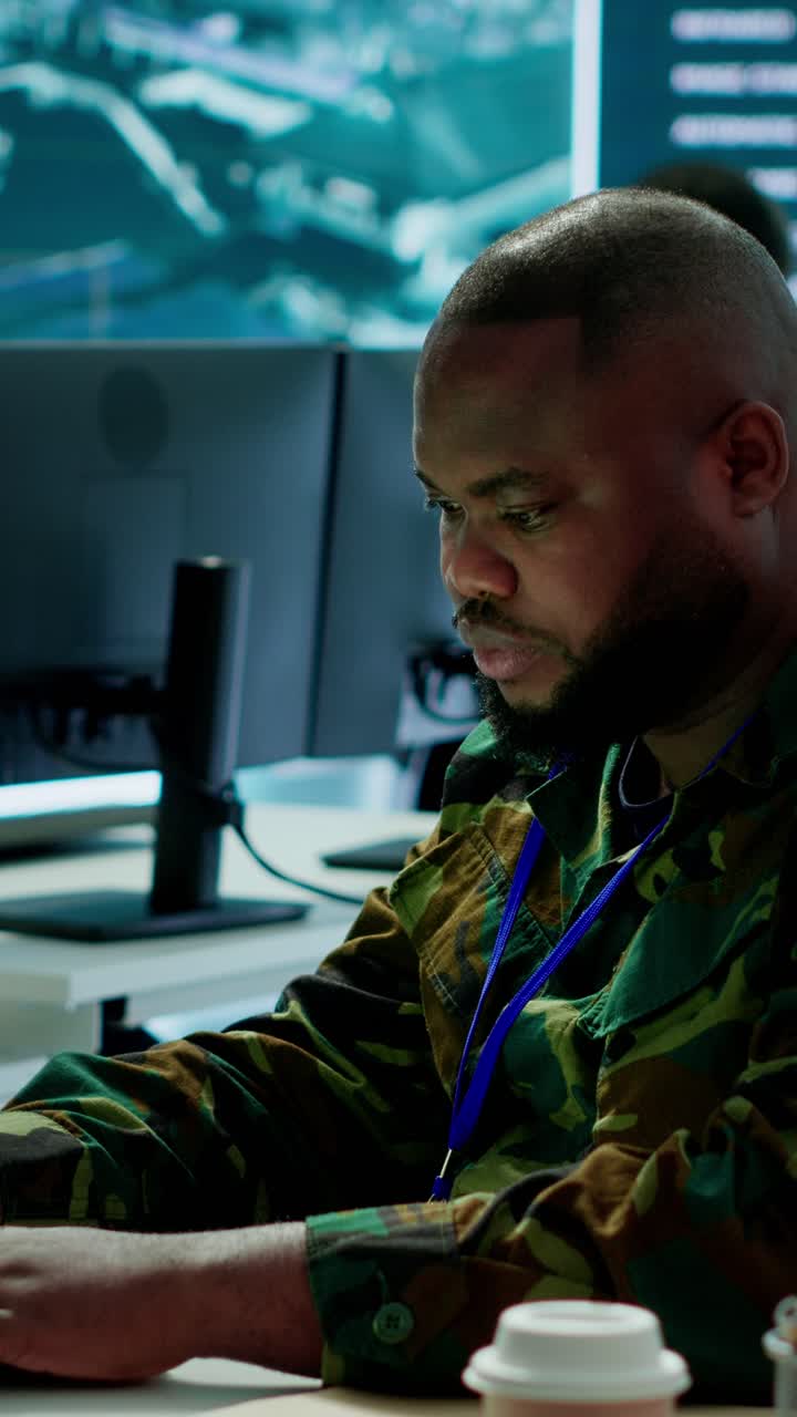 Vertical Video Team of military professionals in control center monitors satellite intelligence