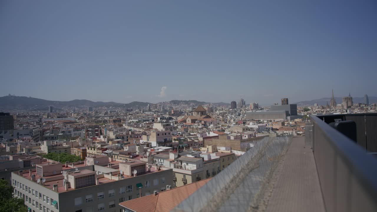 Building Ledge View, Overview of Barcelona Spain in the Early Morning as Birds Fly Along City Skyline in 6K