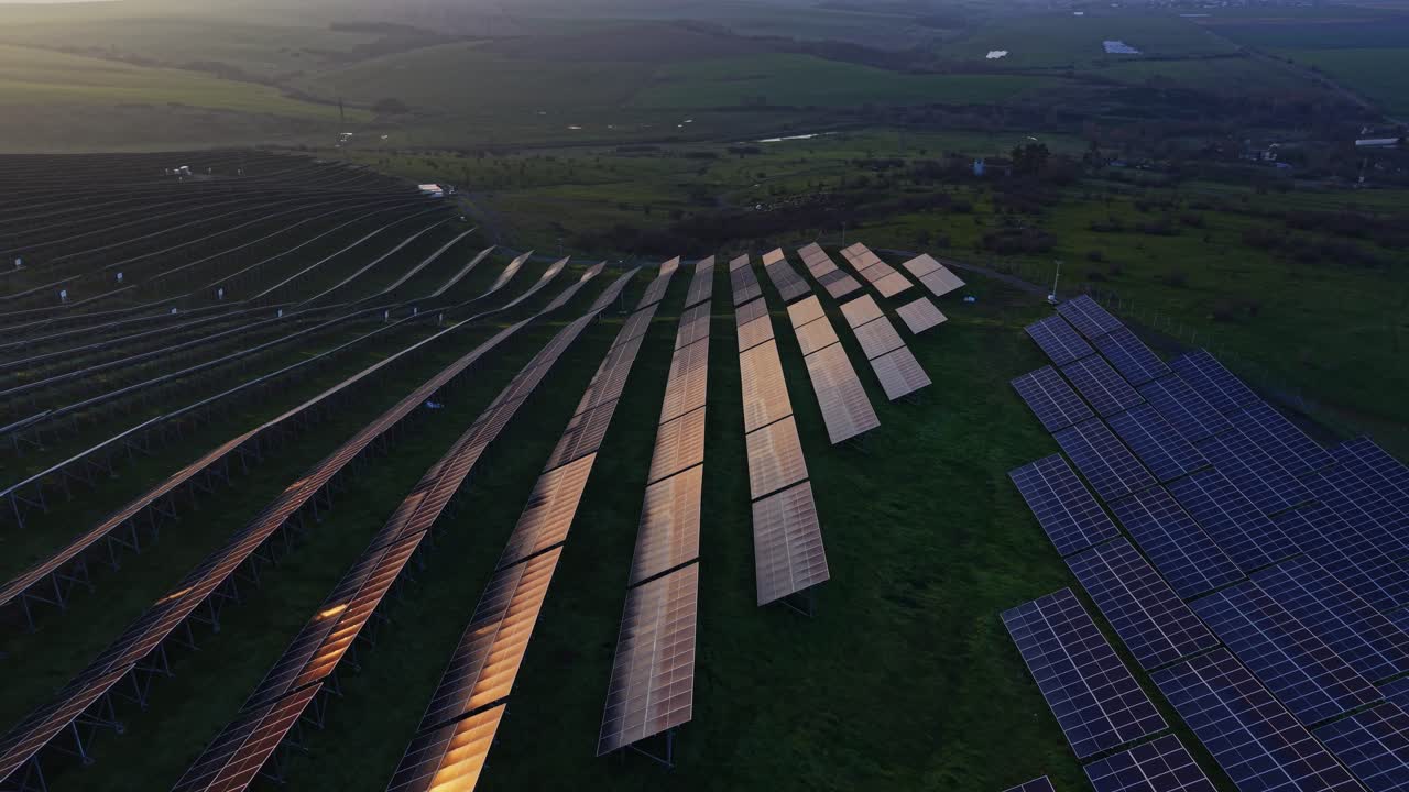 Solar panels capture sunlight on a field during late afternoon